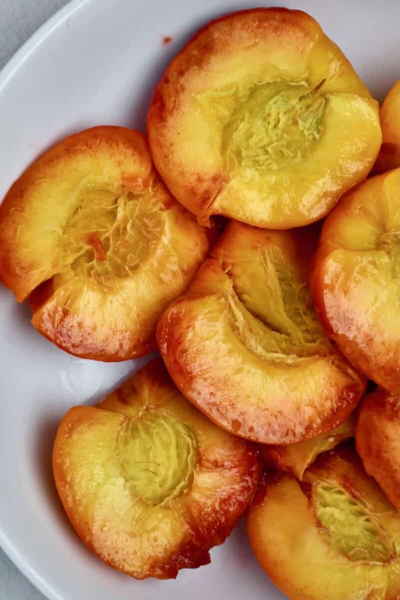 Peaches after blanching and peeling and removing the pitts.