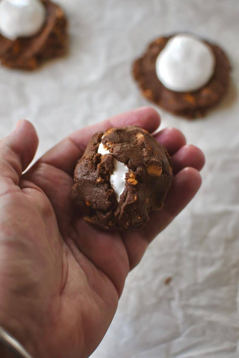 Folding up the cookies to encompass the marshmallow cream.