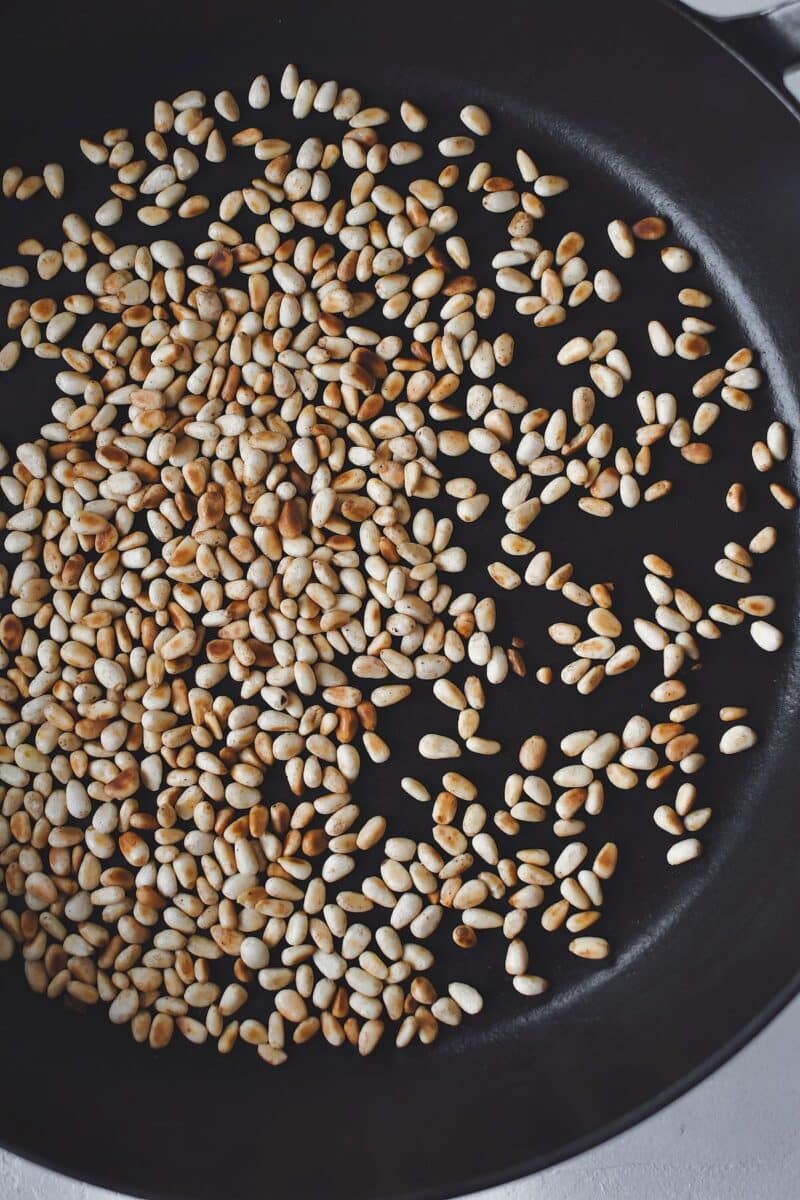 Toasting pine nuts in a dry skillet.