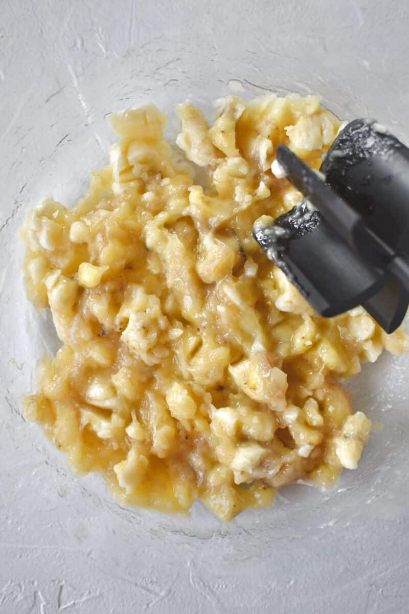 Mashing bananas to make bread.