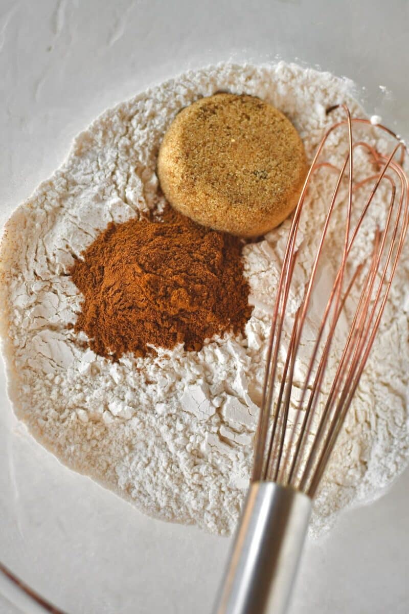 Whisking together the flour, pumpkin spice, and brown sugar before cutting in the butter.