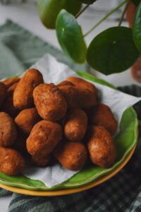 Irish Potato Candy that look like "Tiny potatoes" on a plate ready to be eaten.