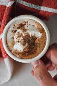 A cup of Nutella Hot Chocolate in hand, ready to drink.