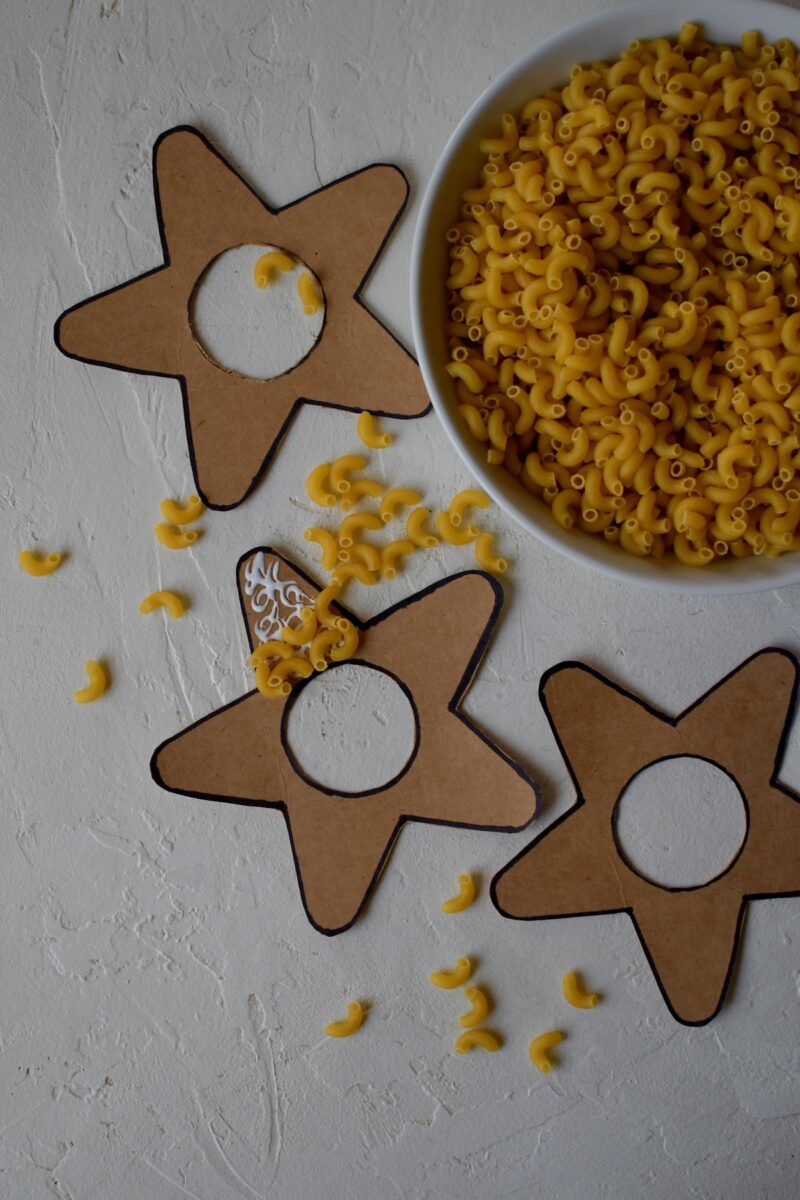 Cut out stars, with the middle cut out also, gluing macaroni noodles to them.