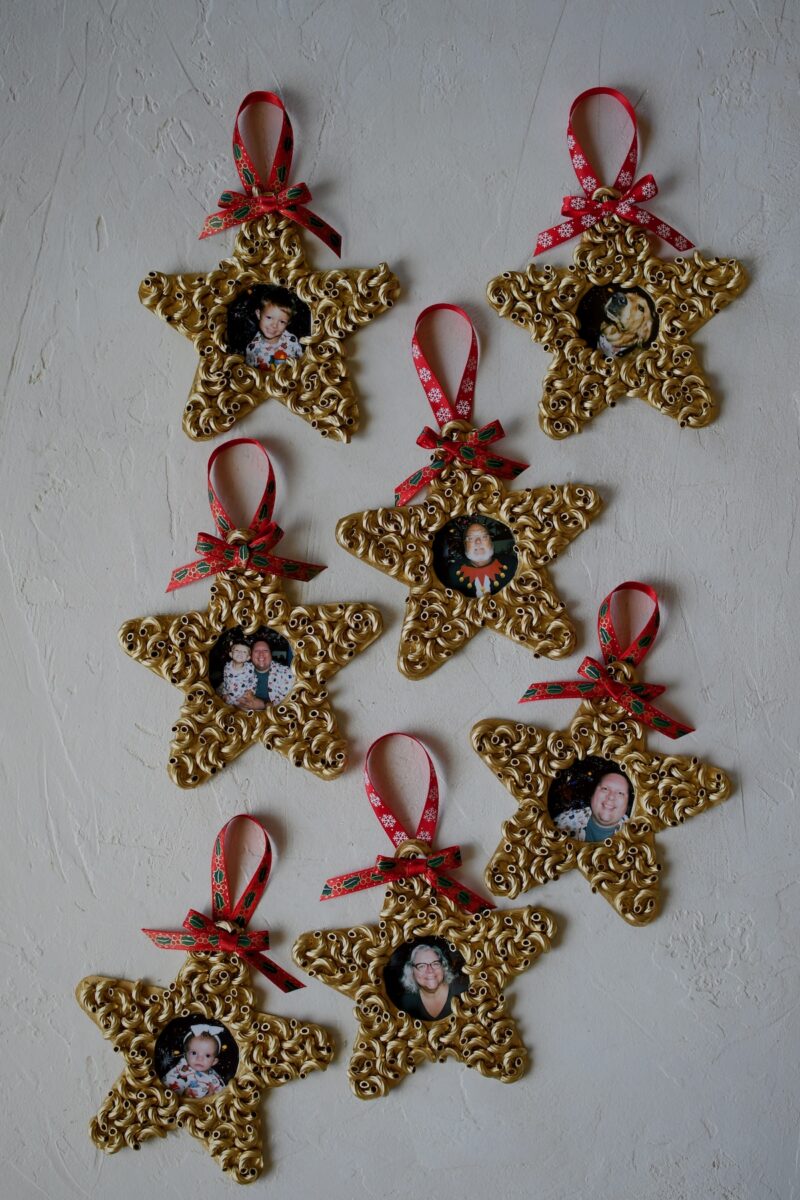 Pictures have been cut to size and glued to the back of the ornaments, and the easy pasta christmas ornaments are complete and ready to hang on the tree.