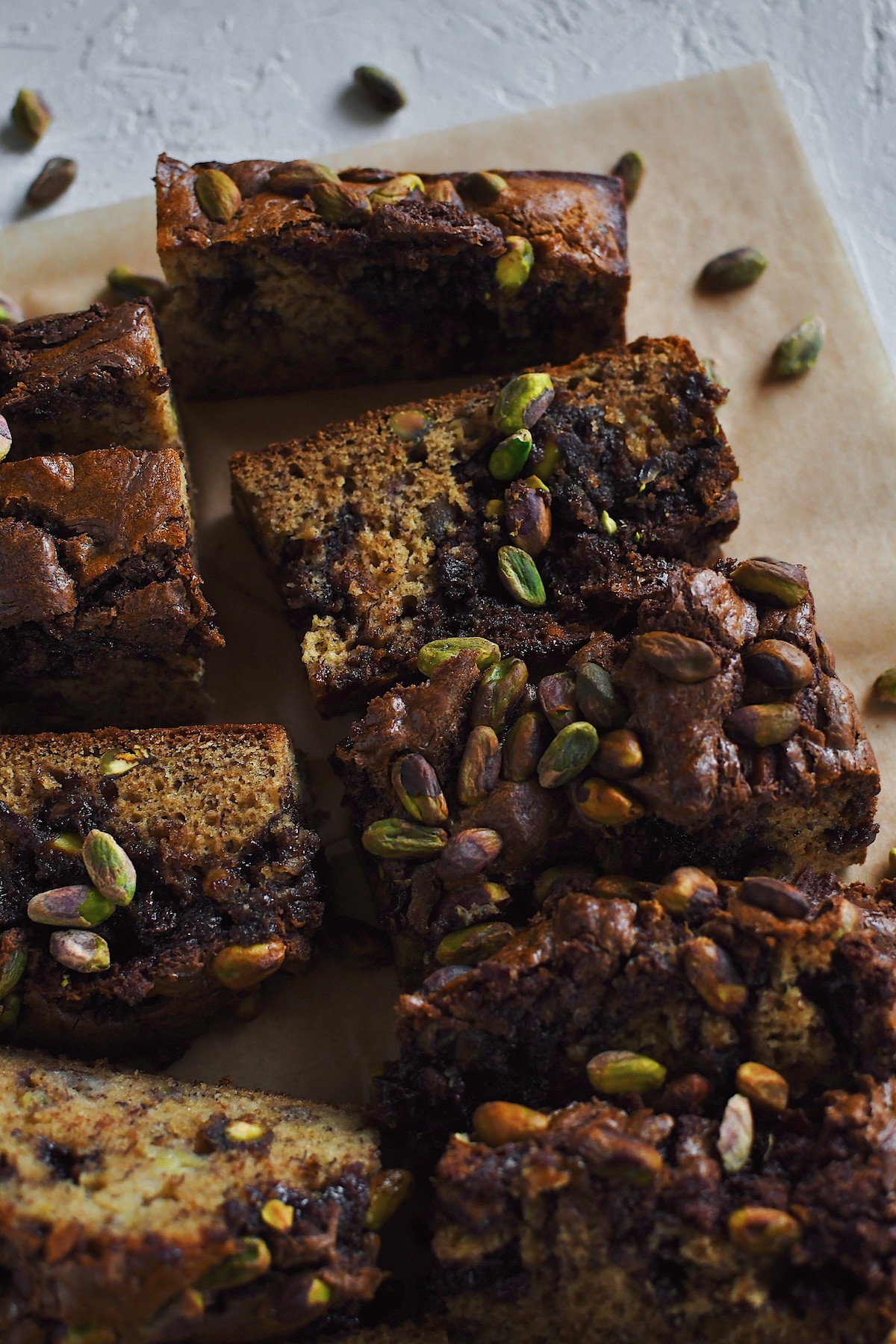 Looking into a sliced loaf of Dubai Chocolate inspired Banana Bread, studded with pistachios and swirled with nutella.