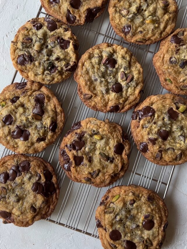 Pistachio Chocolate Chip Cookies on a cooling rack, waiting to be eaten.