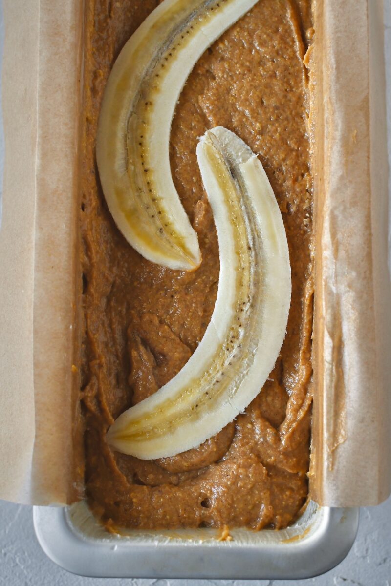 Halved banana added on top of the batter.