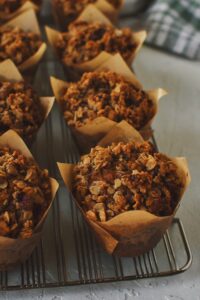 Looking at the Pumpkin Banana Muffins on a cooling rack, side view.