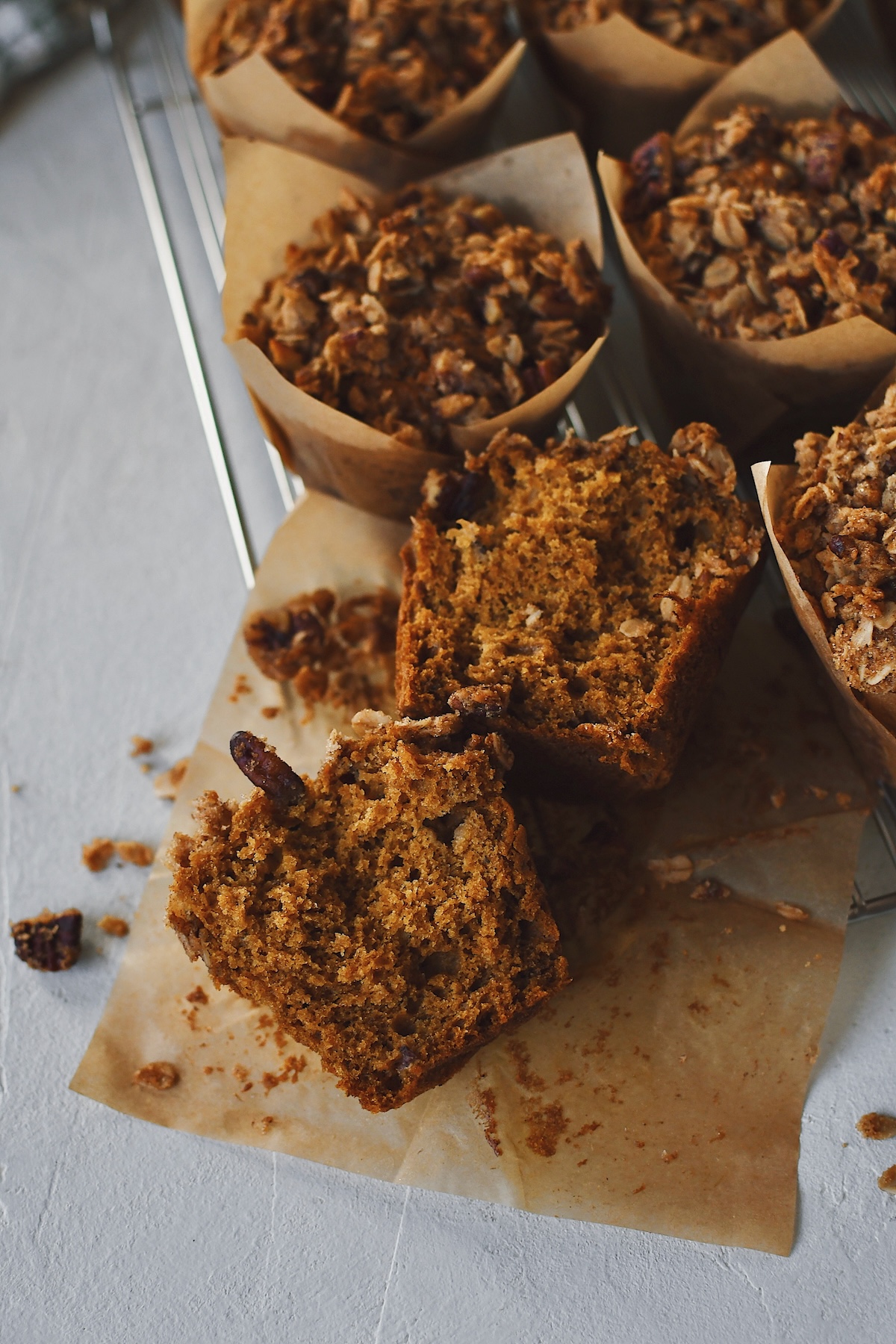 Pumpkin Banana Muffins, one with the wrapper removed and split in half.