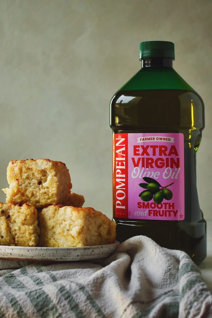 Olive Oil Swim Biscuits on a plate next to the olive oil I used to make them.