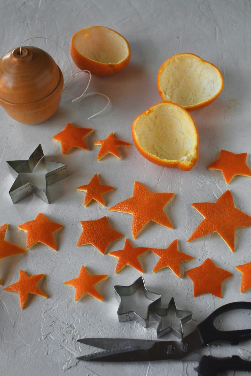 Cut out orange peel stars laid out on a table.