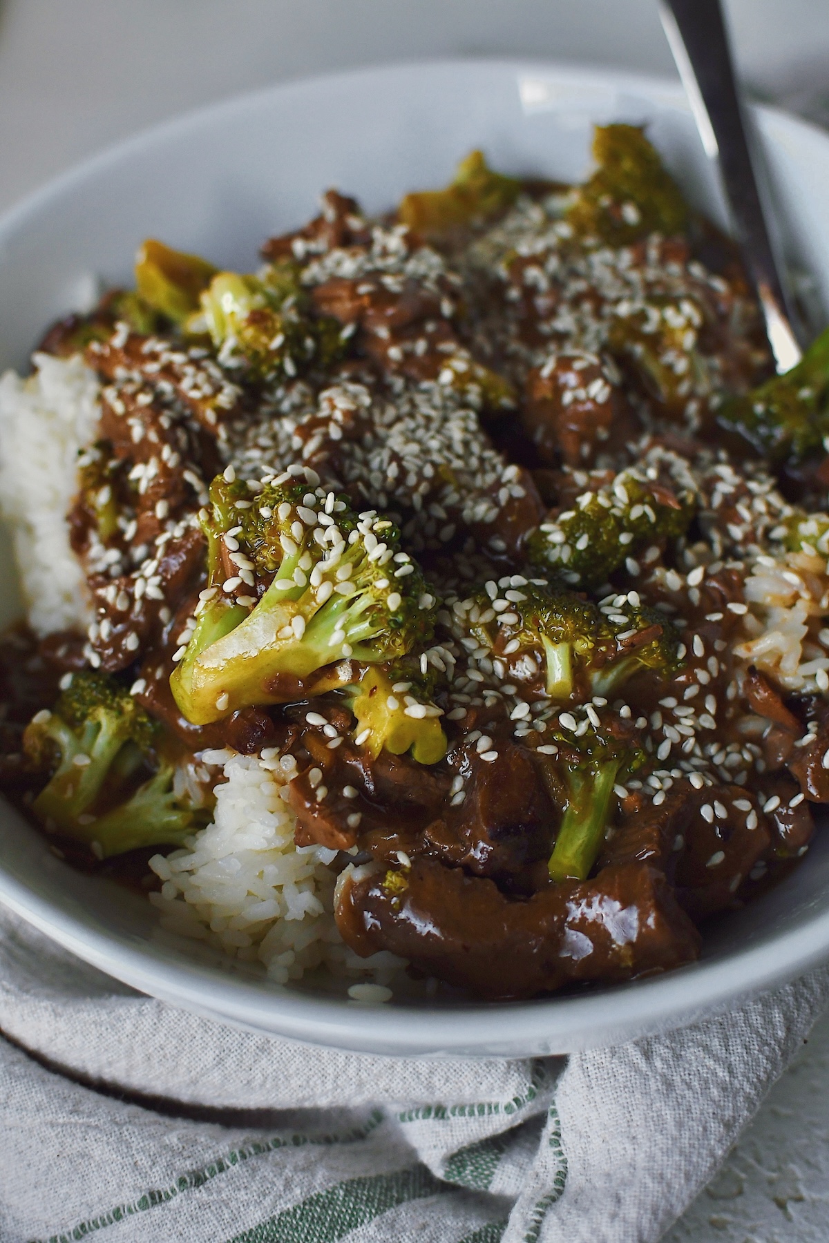 Served over rice, a bowl of Slow Cooker Beef and Broccoli.