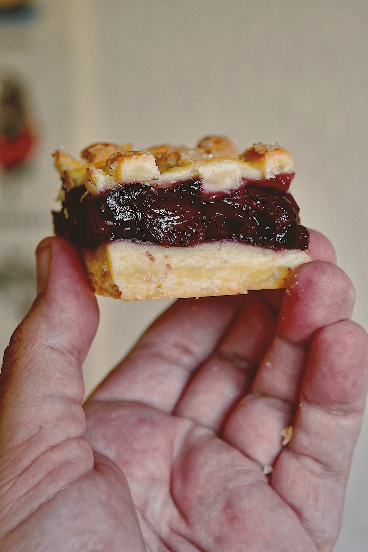 Holding up a Cherry Pie Bar so you can see all the layers!